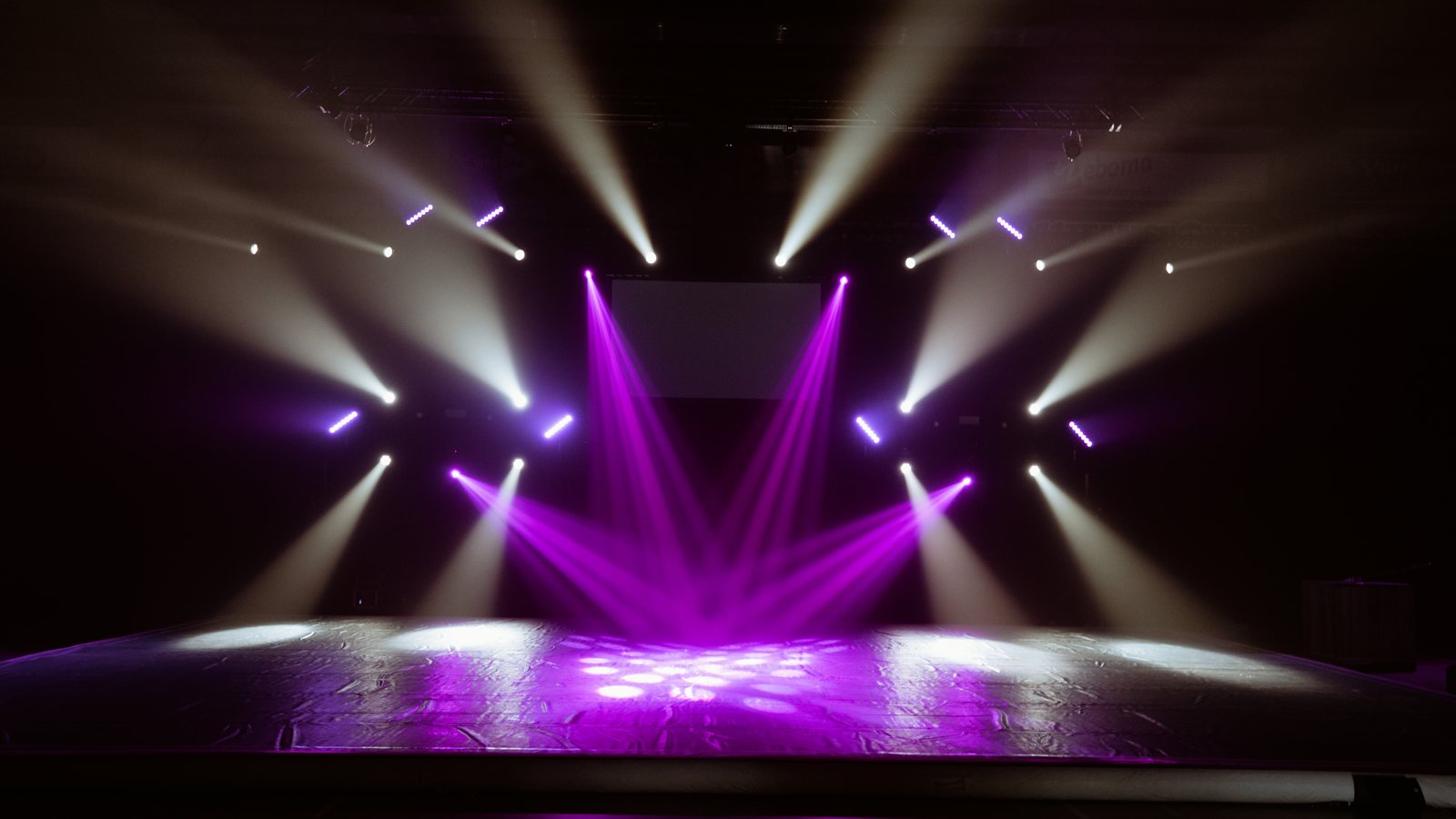 Lichtshow met paarse en witte bundels